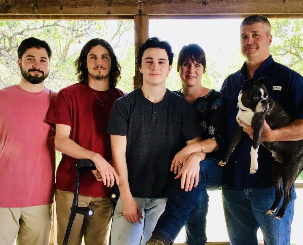 four men and a woman with a dog