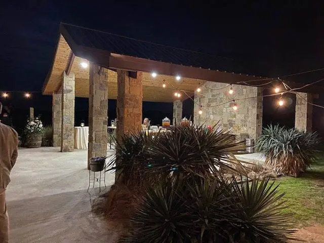 El Cerrito open building next to the main building night view plants and hanging lights