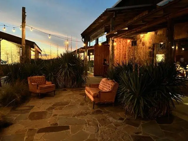 night time outside El Cerritos Lodge with two sofa and hanging lights