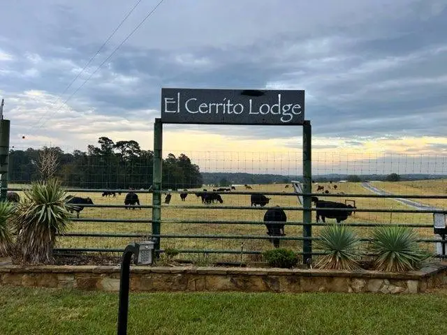 El Cerrito Lodge Signage the field and the black cows