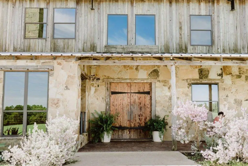 beautiful pink flower garden at the entrance with wooden door