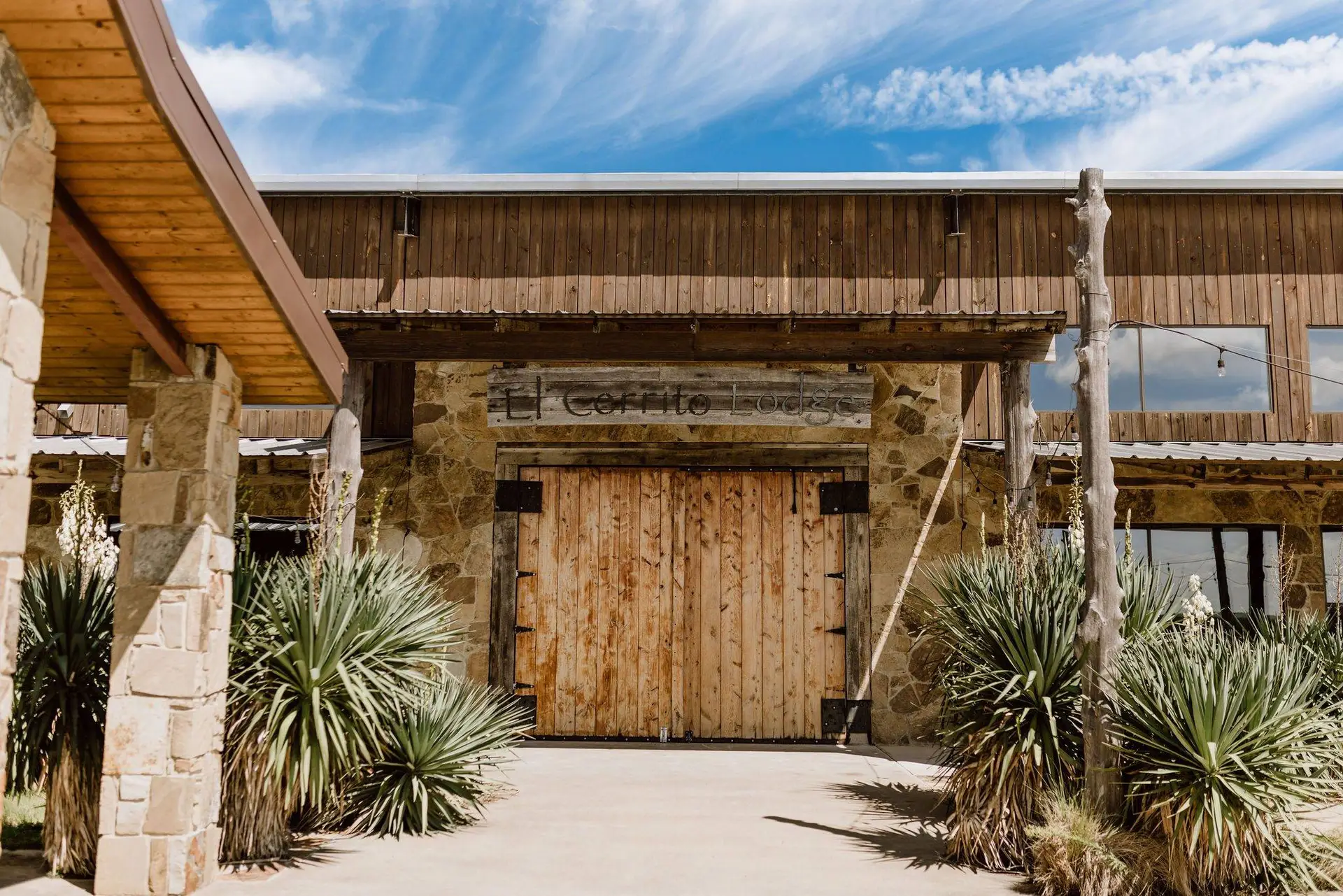 wooden door entrance and green plants at the side walk
