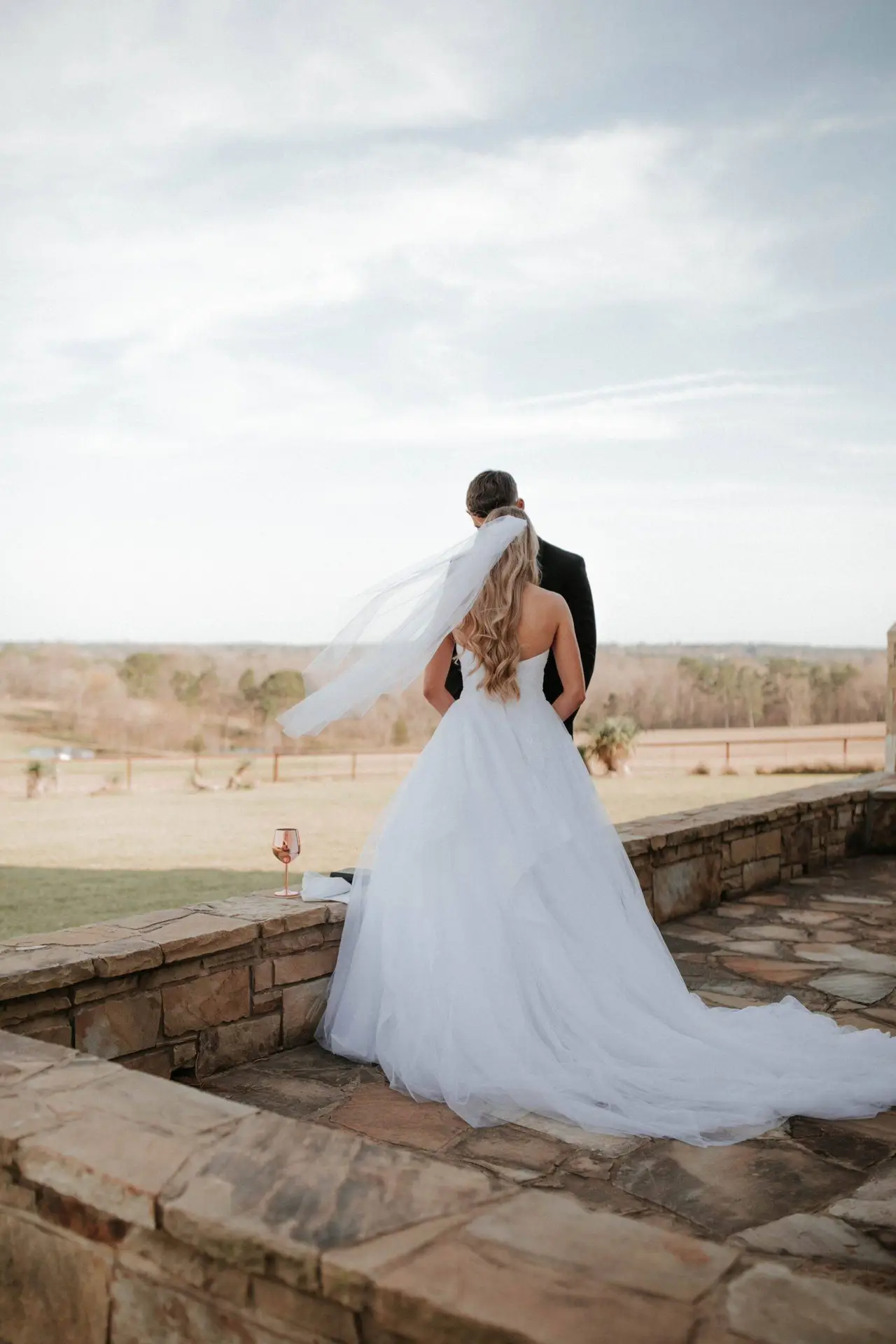 Groom and bride with green field and trees