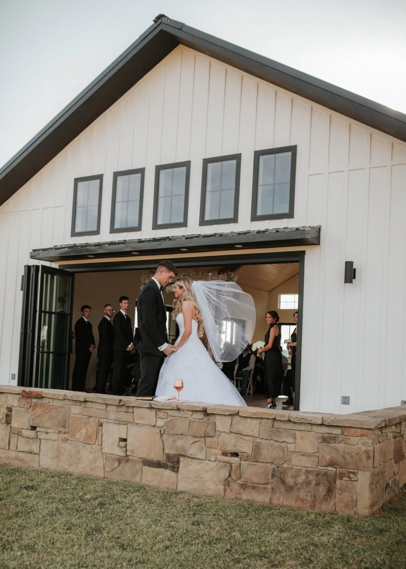 Bride and groom wedding venue white wall black window frame