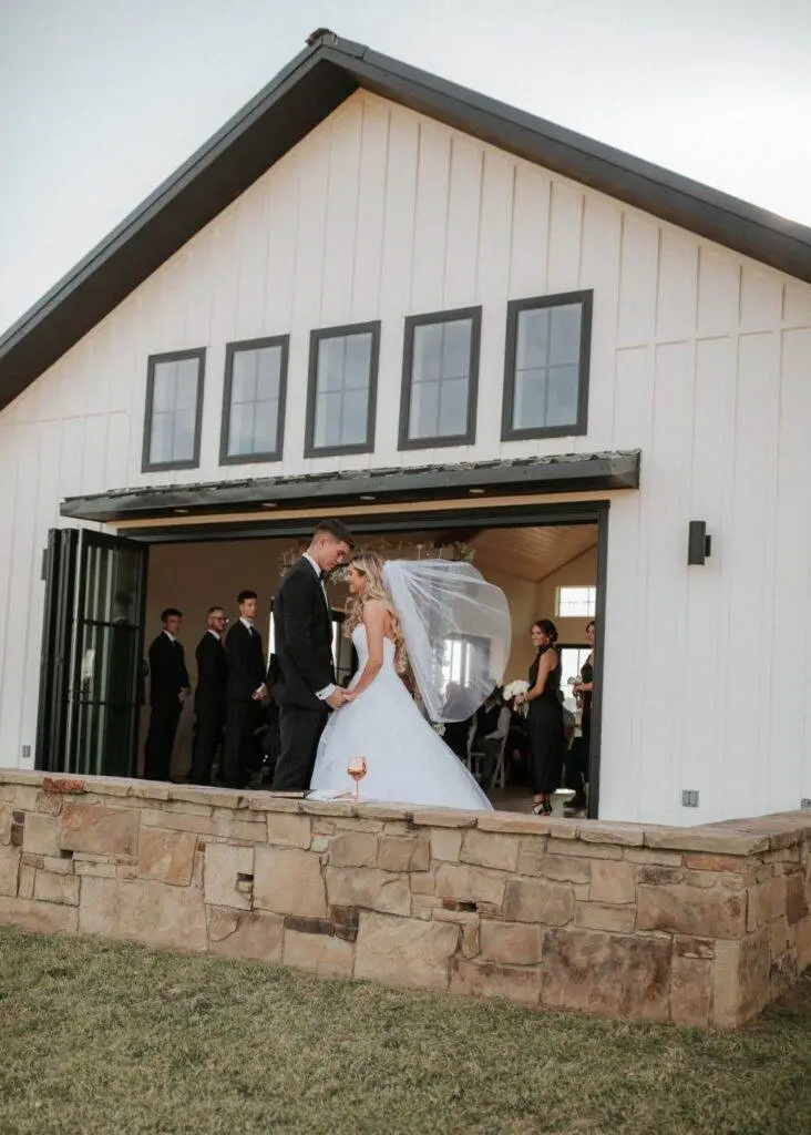 Bride and groom wedding venue white wall black window frame