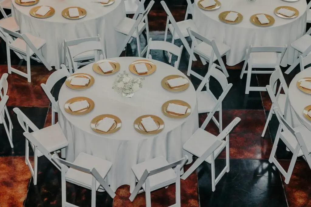 Elegant El Cerrito venue with round tables, white linens, gold accents, and white chairs—perfect for stylish weddings or events.